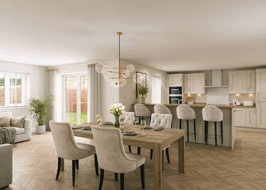 Open-plan kitchen and dining area in a new-build home with neutral decor, wooden flooring and contemporary lighting