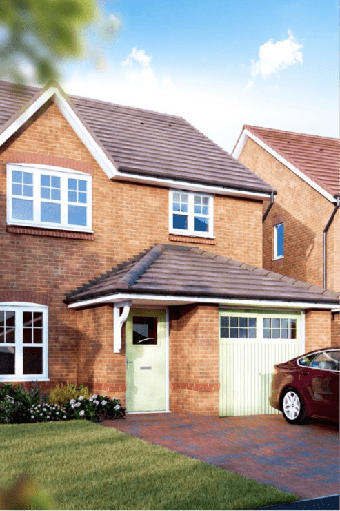 Exterior of a modern brick detached house in the UK with a pale green front door and garage, and a block-paved driveway