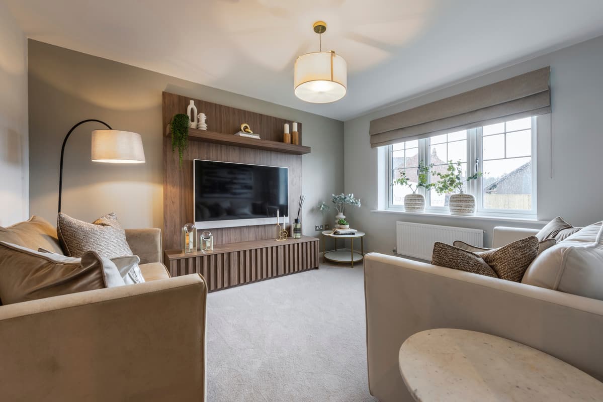 Modern neutral living room with two sofas, a wood panel feature wall with television, and a window with roman blinds