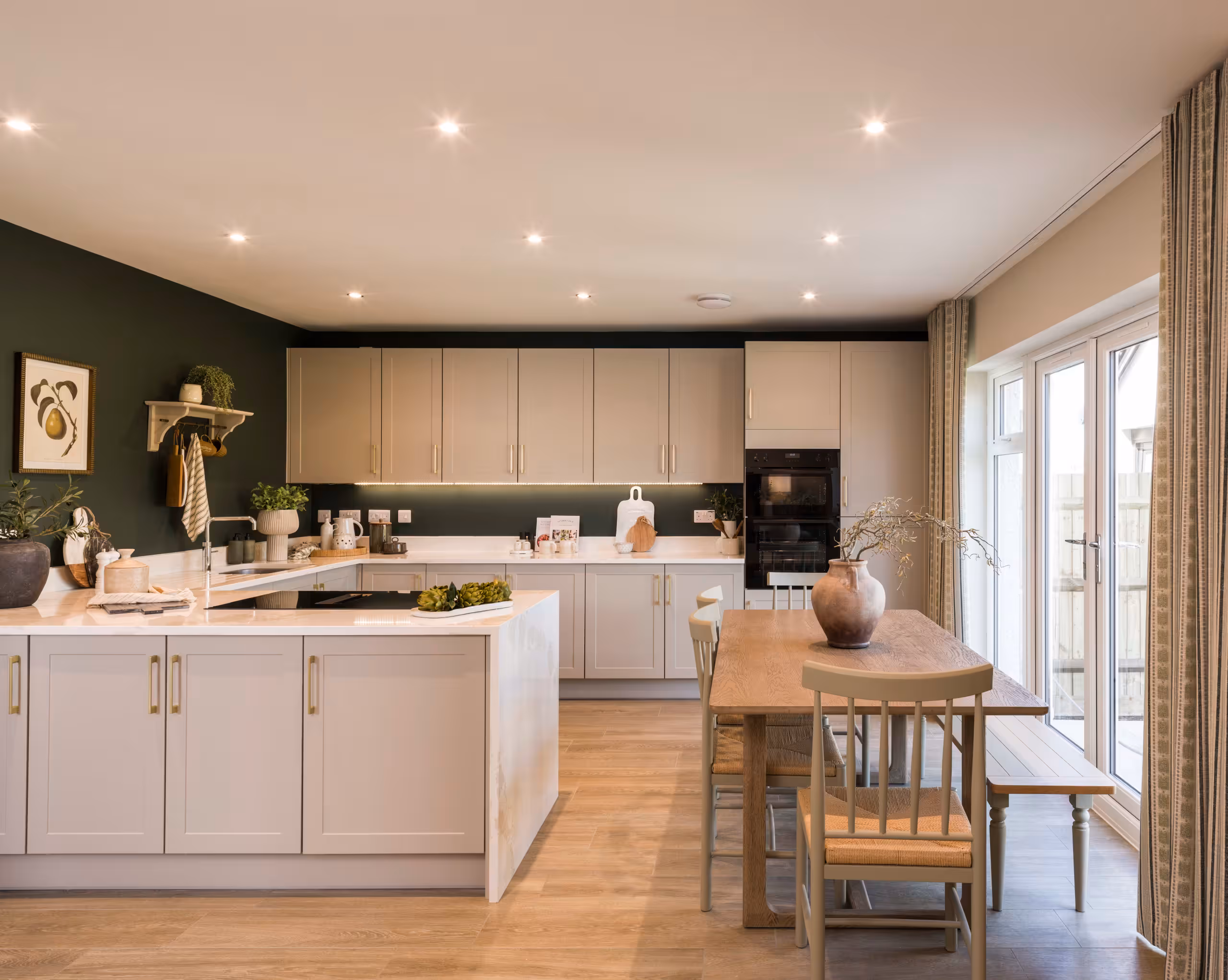 Modern kitchen with neutral cabinets, a central island, and an adjacent dining area featuring French doors to the garden