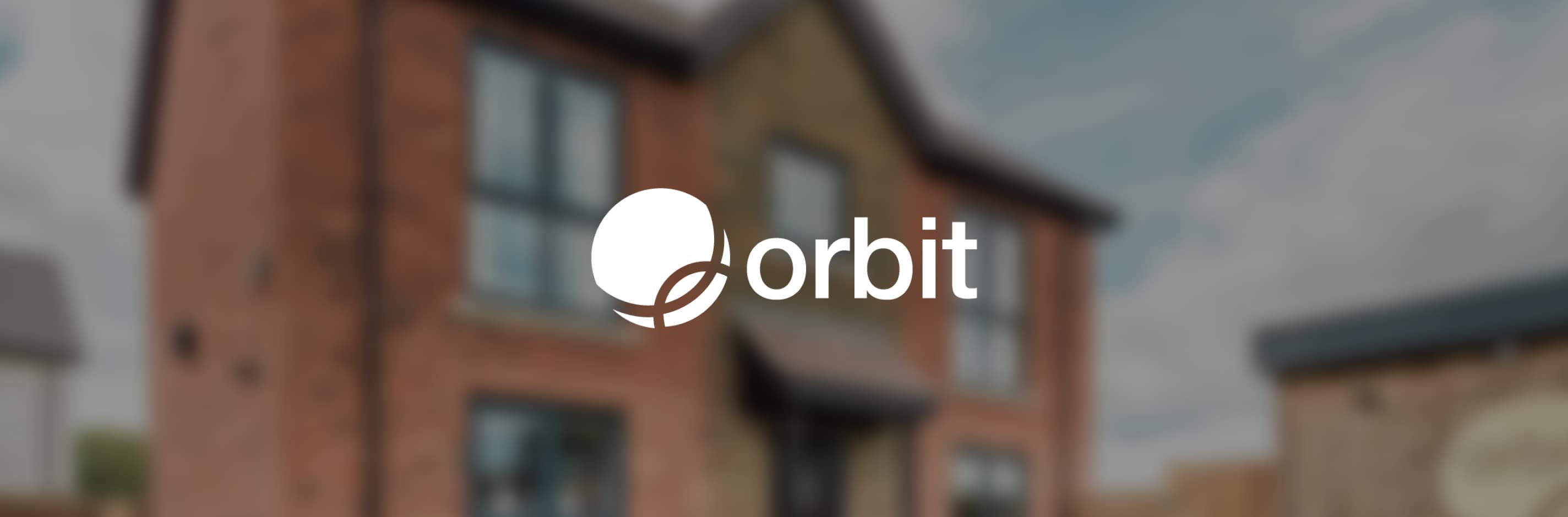 Orbit logo centred over a blurred background of a modern brick new-build house exterior