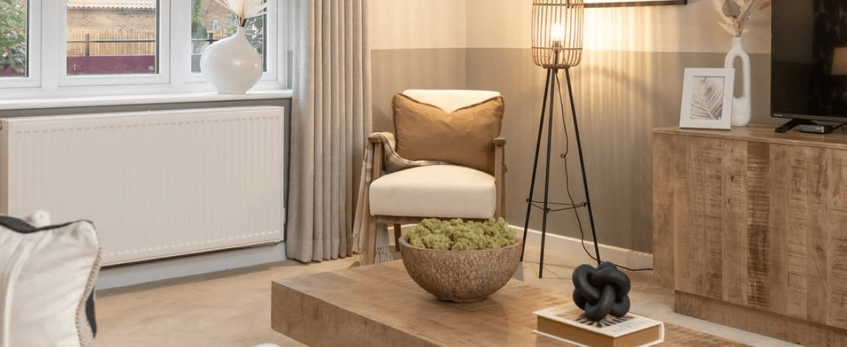 Modern living room interior with a cream armchair, wooden coffee table, floor lamp and neutral decor styling